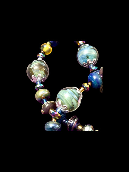 Handmade glass bead necklace and bracelet set in blues, greens and metallic glass, crystals and sterling silver bead caps.