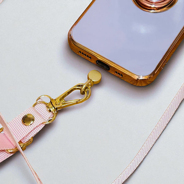 Smartphone with a gold case and pink lanyard on a light gray background