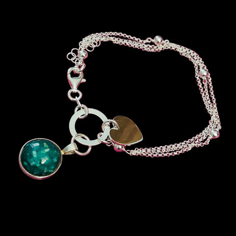 Precious Ashes cabochon pendant on a sterling silver multi strand bracelet